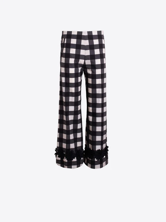 Black and white checkered pants with ruffled hem on a white background