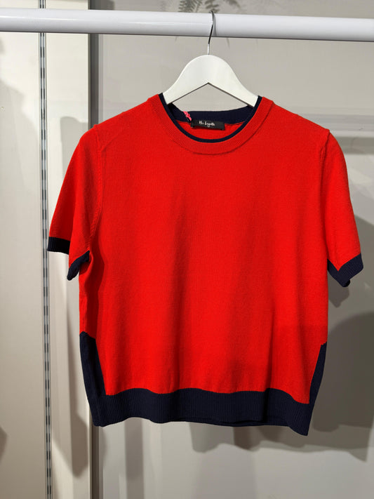 Red sweater with navy accents on a hanger against a neutral background