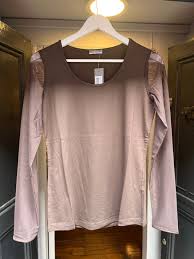 Round neck top with mesh sleeves perfect for layering.