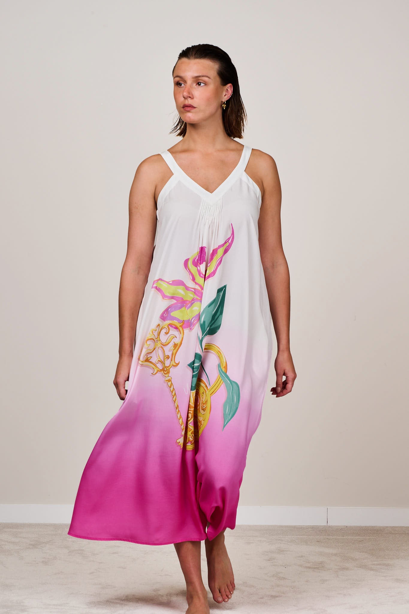 Sleeveless white to pink ombre midi dress with tropical floral print and v-neckline, styled for summerwear