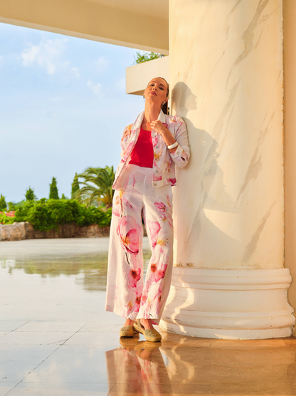 Model styled in ivory watercolour floral trousers and matching jacket inspired by artist Kraf, worn with pink top