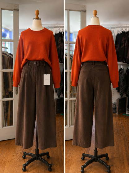 rust-orange long-sleeve knit sweater and dark brown wide-leg corduroy pants, shown from both front and back views.
