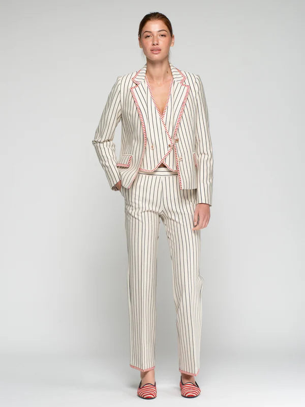 Woman wearing a striped suit with a plain background
