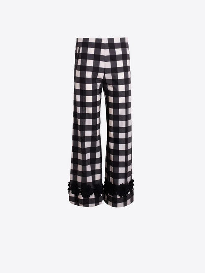 Black and white checkered pants with ruffled hem on a white background
