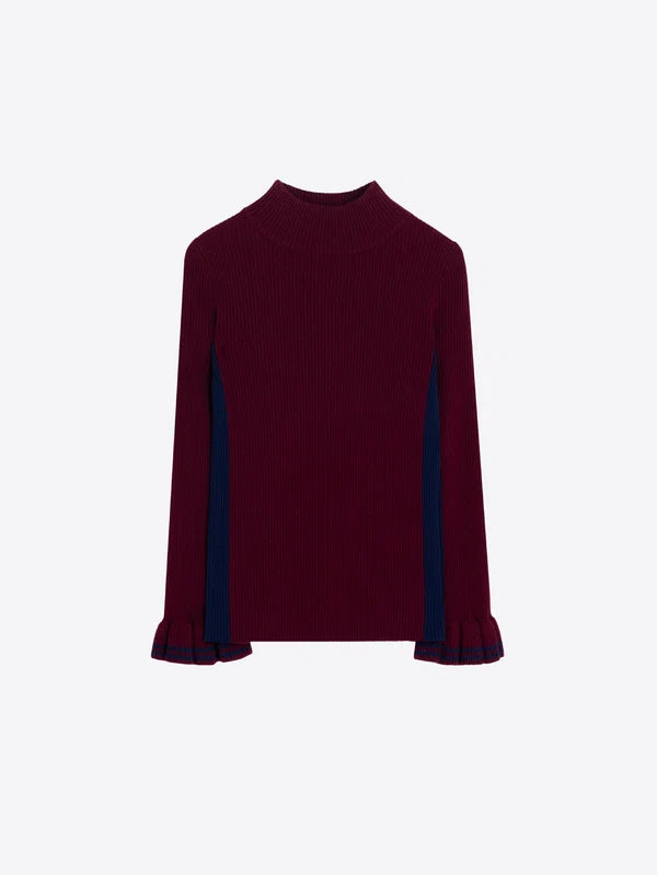 A ribbed knit long-sleeve top in deep burgundy with contrasting dark navy blue panels along the sides of the sleeves, shown against a plain light gray background.
