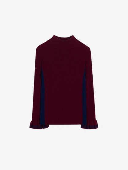 A ribbed knit long-sleeve top in deep burgundy with contrasting dark navy blue panels along the sides of the sleeves, shown against a plain light gray background.