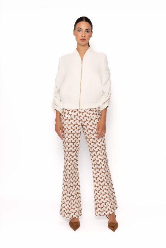 Woman wearing a white zip-up bomber style jacket 