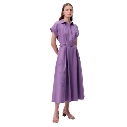 Woman wearing a purple dress with a belt 