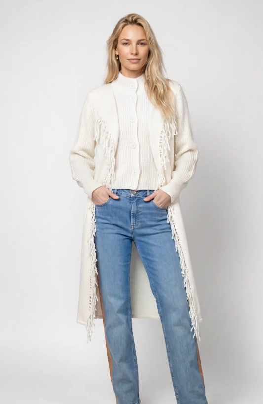 A long cream-colored knit cardigan with fringe details, 