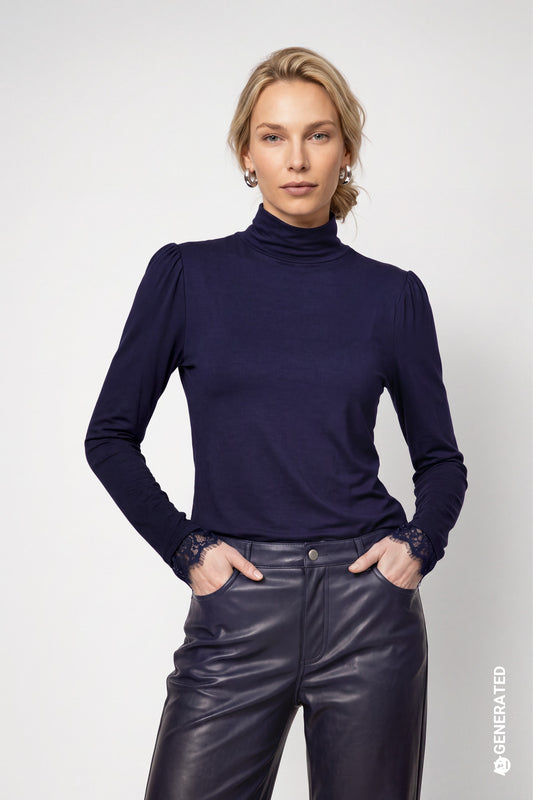 A woman modeling a dark navy blue long-sleeve mock neck top with sheer lace cuffs, 