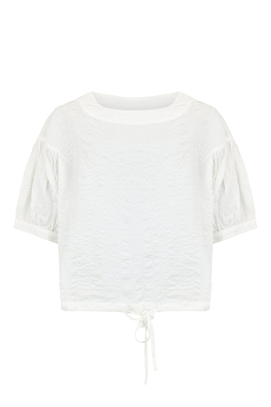 Women’s white textured short sleeve blouse with round neckline and adjustable tie-front hem detail.