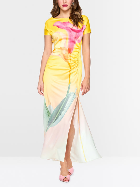 Woman wearing a colorful dress with floral design, occasion wear 