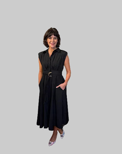 Woman in a black dress standing in a clothing store 