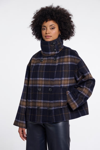 a cropped, double-breasted plaid coat with a high mock neck collar. The coat features a navy blue base with brown, beige, and light blue plaid stripes.