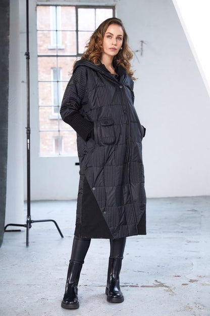 Woman wearing a black quilted coat 