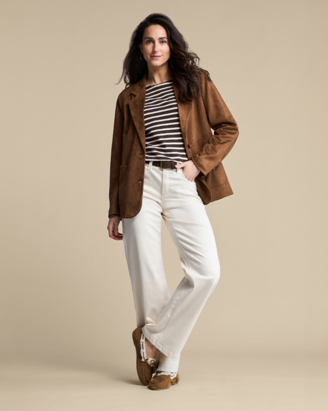 A woman modeling a brown suede blazer from Red Button