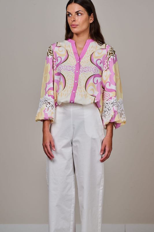 Women’s printed blouse with pink and cream ornamental swirl design, lace sleeve detailing, three-quarter length sleeves, and contrast button placket, worn by a female model on a neutral background.
